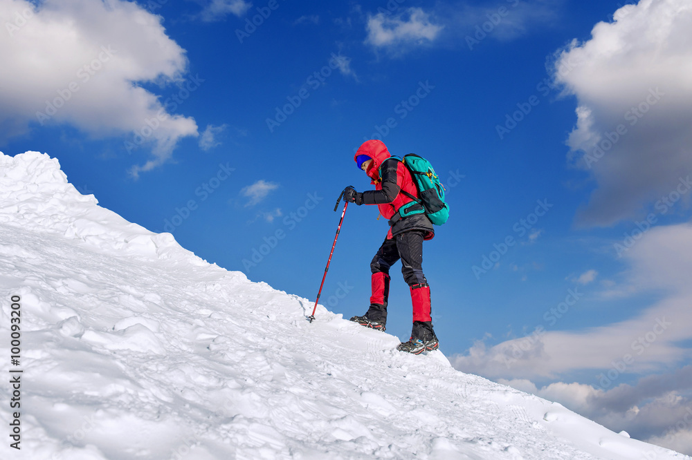 The man in the winter journey with a backpack on the background