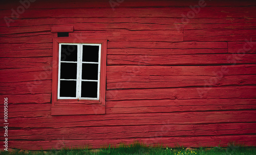 Red wooden wall with white window
