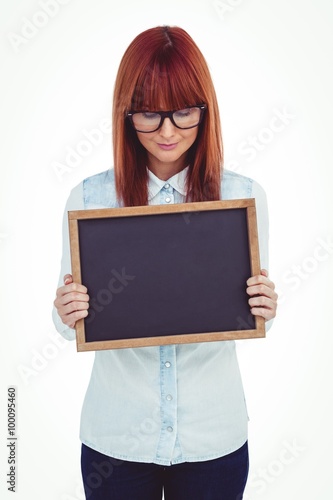 Smiling hipster woman holding blackboard