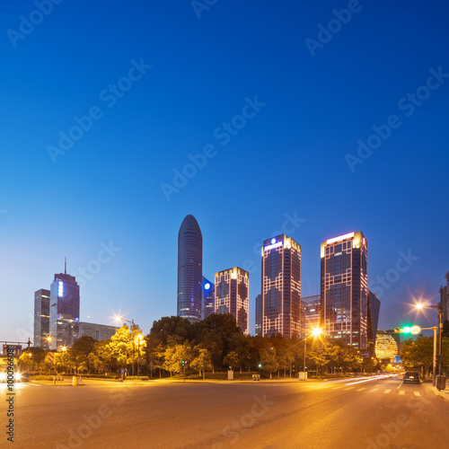 traffic on road and modern building in clear sky at dawn © zhu difeng