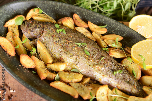 Roasted trout with potatoes in thyme
