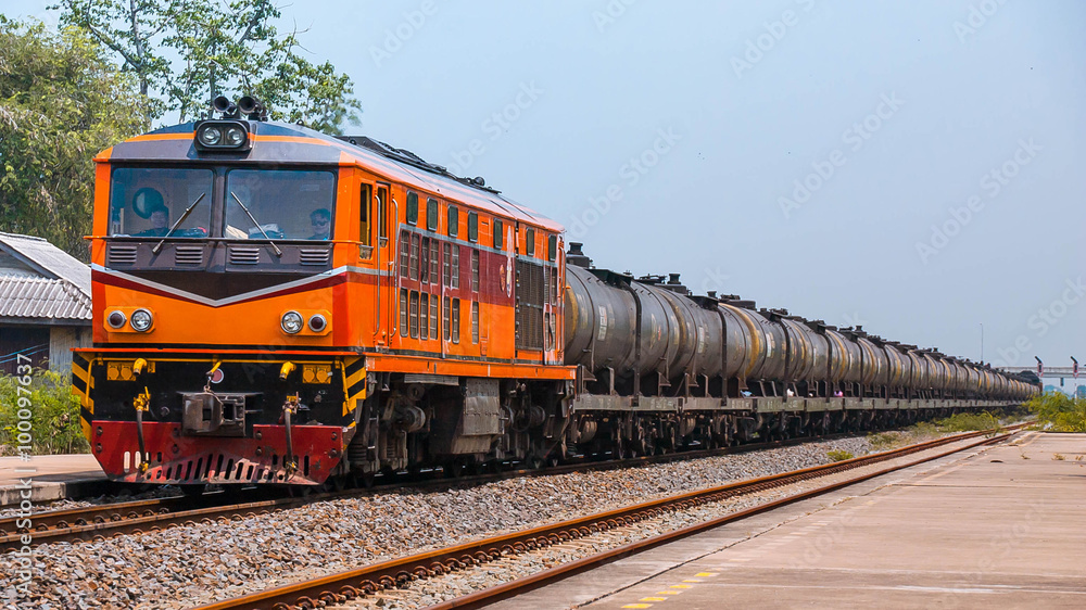 Passenger train  passing through rural station, 2015.