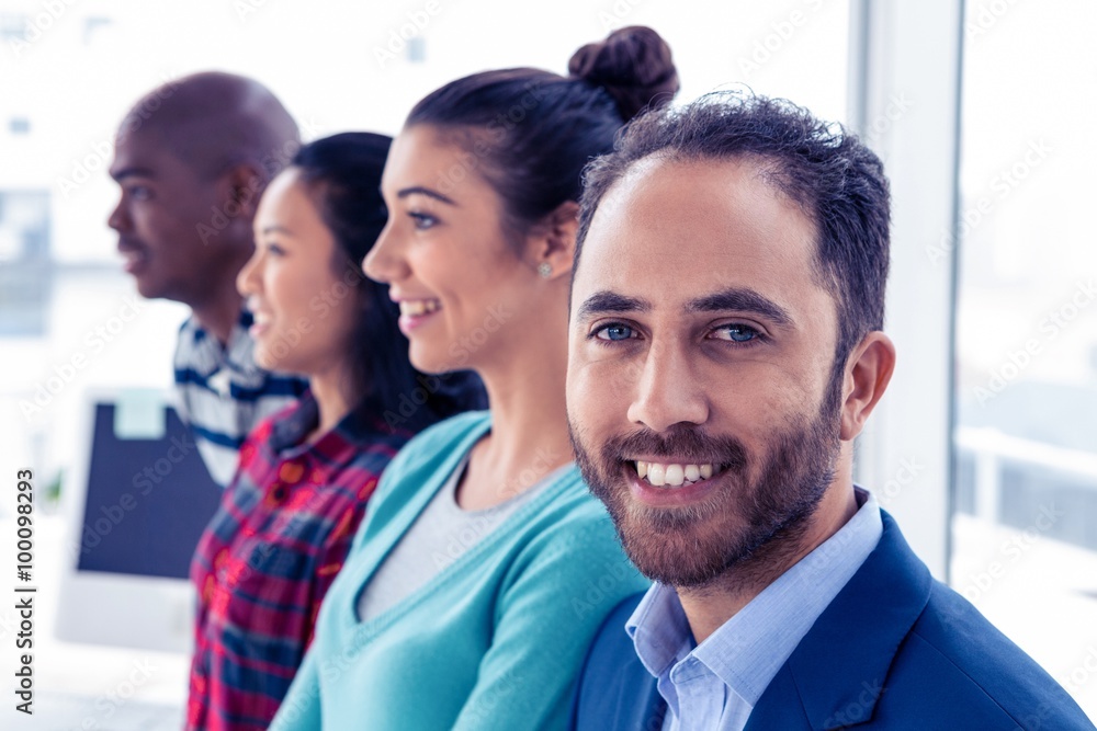 Obraz premium Portrait of young businessman with colleagues