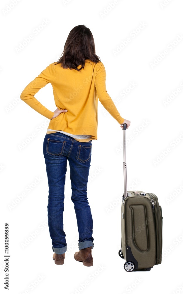 back view of walking woman in cardigan with suitcase. back view of walking woman in cardigan with suitcase.