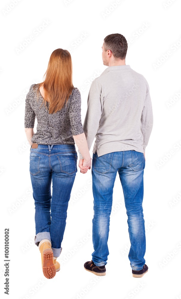 Back view of young embracing couple (man and woman) hug and look Back view of young embracing couple (man and woman) hug and look