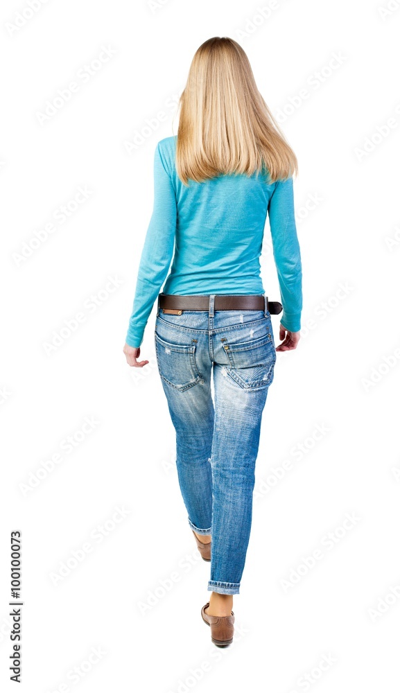 Obraz premium back view of walking woman.