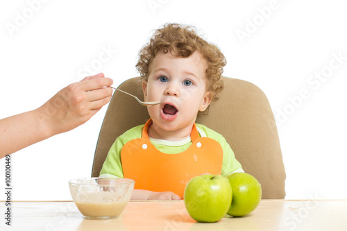 Mum spoon-feeds the child