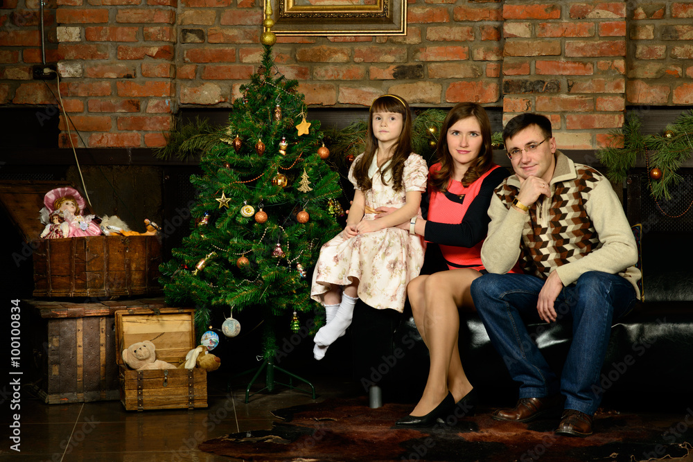 Family new year's eve around the Christmas tree Family new year's eve around the Christmas tree