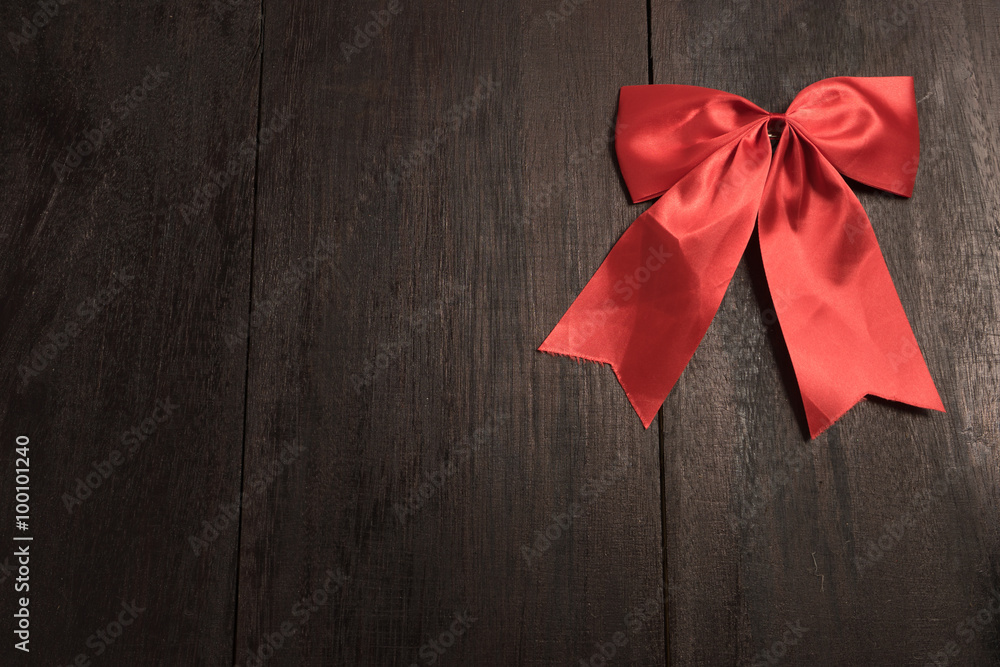 Red bow on old wood Red bow on old wood
