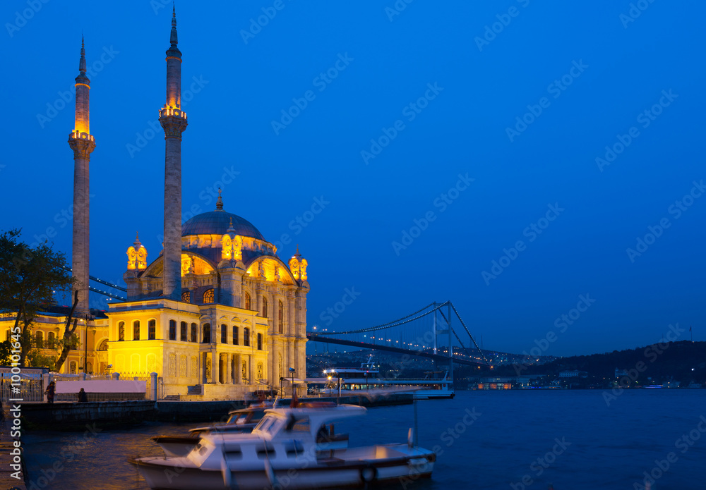 Ortakoy Mosque in night lights, in the background the bridge over the Bosphorus, Istanbul