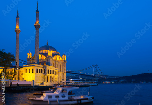 Ortakoy Mosque in night lights, in the background the bridge over the Bosphorus, Istanbul