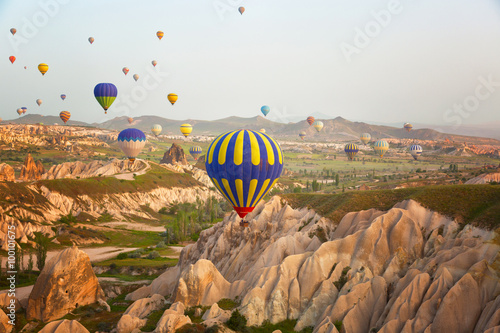 Multi-colored balloons in the sky of Cappadocia at sunrise, Turkey