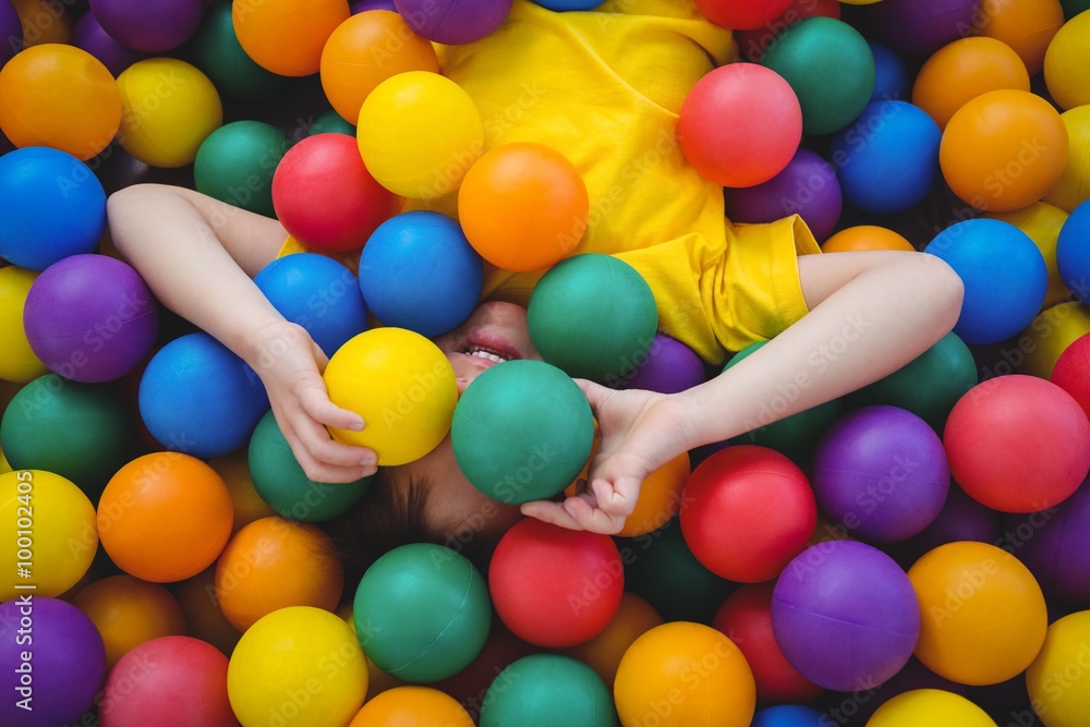 Cute smiling boy in sponge ball pool Cute smiling boy in sponge ball pool