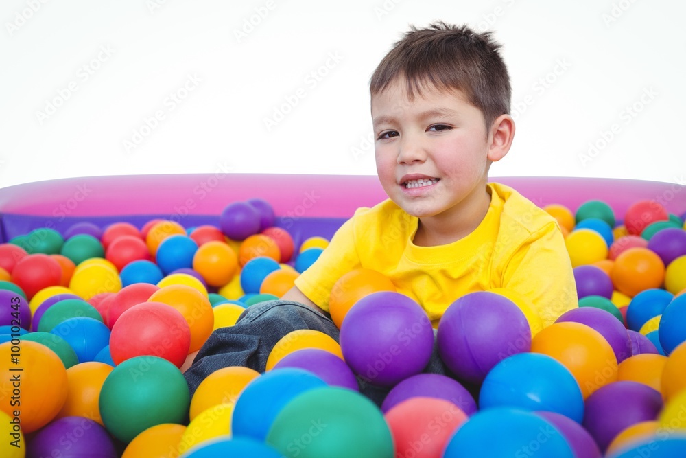 Fototapeta premium Cute smiling boy in sponge ball pool