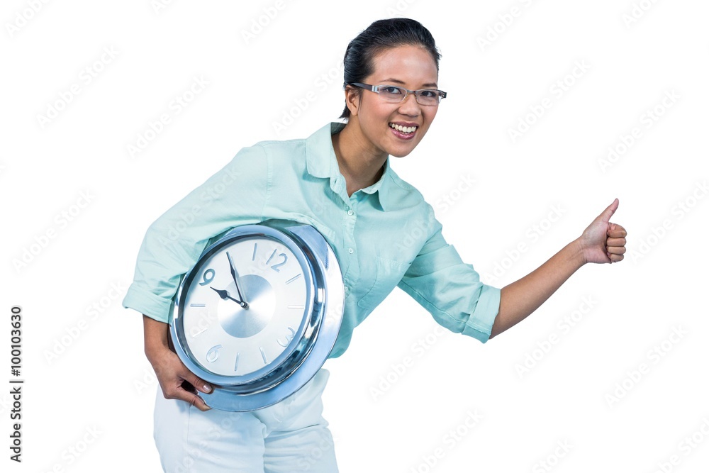 Delighted businesswoman holding a clock Delighted businesswoman holding a clock
