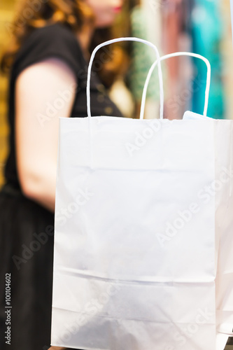 shopping bags standing at the checkout. An empty package