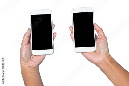 Businesswoman holding smartphone in each hands 