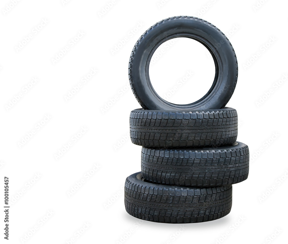 The stack of four winter new tires over white The stack of four winter new tires over white