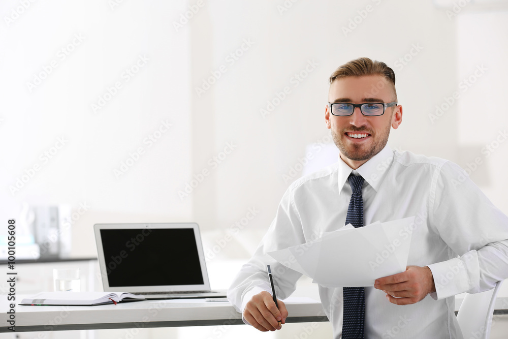 Businessman working with laptop in office Businessman working with laptop in office