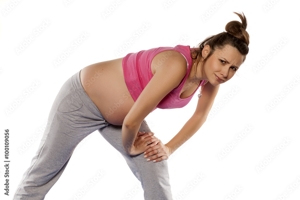 Pregnant woman doing exercises on white background Pregnant woman doing exercises on white background