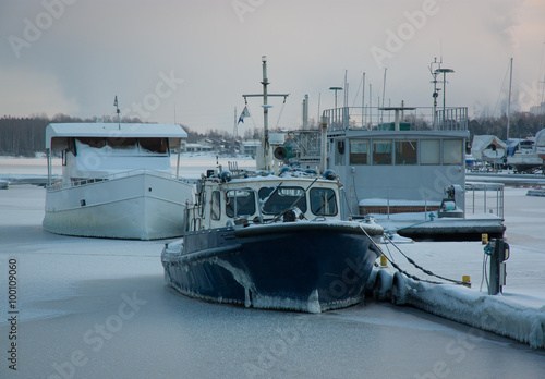 ships at the pier in the ice, frosty morning