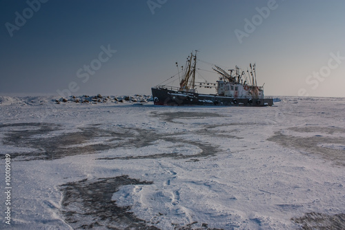 old trawler frozen in the ice
