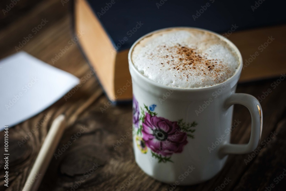 Cup of cappuccino on the wooden table Cup of cappuccino on the wooden table