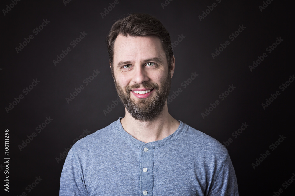 Portrait of a men with beard and mustache in studio black background