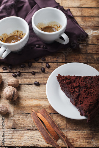 Chocolate cake  coffee and cinnamon sticks