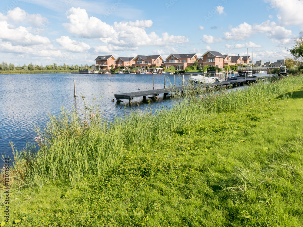 Waterside houses in green residential suburb, Almere in the province of Flevoland near Amsterdam