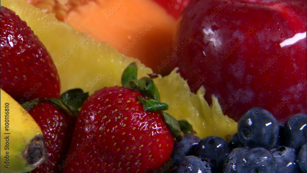 Close shot of an assortment of fruit rotating on a white screen. Close shot of an assortment of fruit rotating on a white screen.