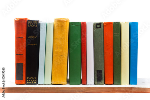 Stack of books at wooden shelf isolated on white background. Back to school. Copy space for text