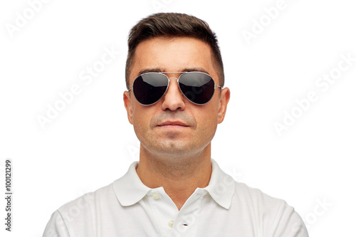 face of man in polo t-shirt and sunglasses