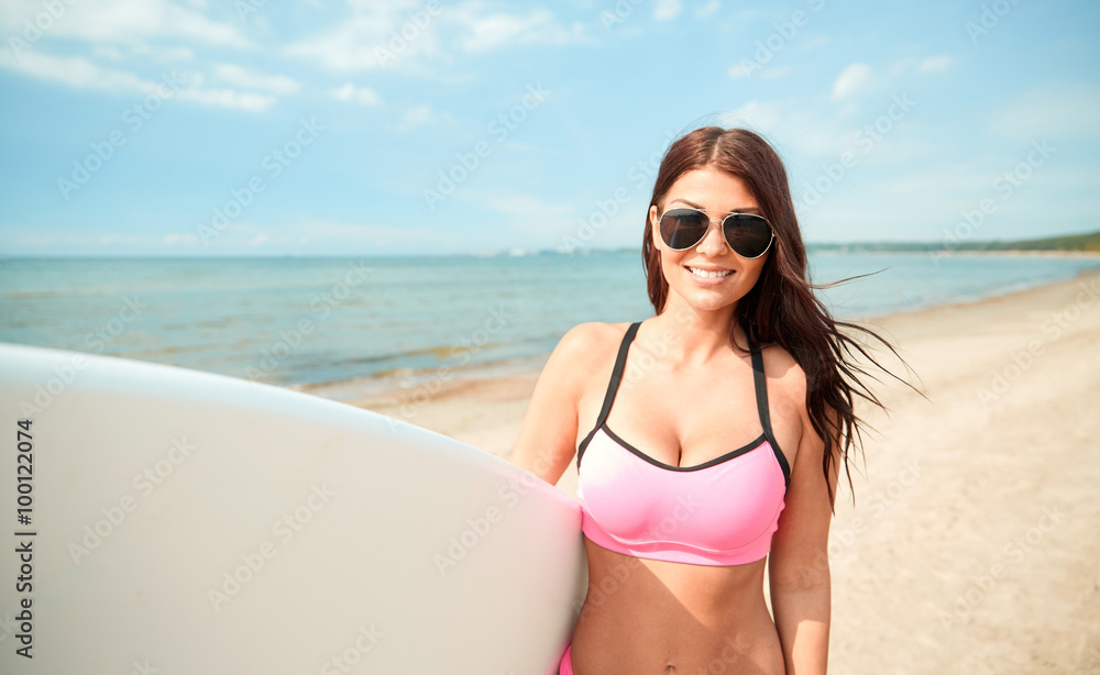 smiling young woman with surfboard on beach smiling young woman with surfboard on beach