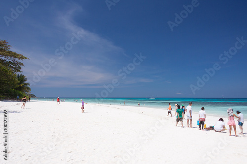 Tourists on white sand beach