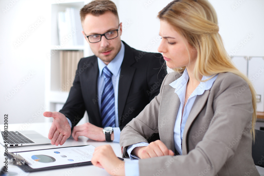 Two successful business partners working at meeting in office Two successful business partners working at meeting in office