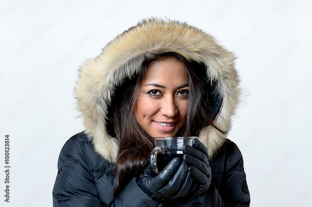Smiling young woman enjoying a hot beverage Smiling young woman enjoying a hot beverage