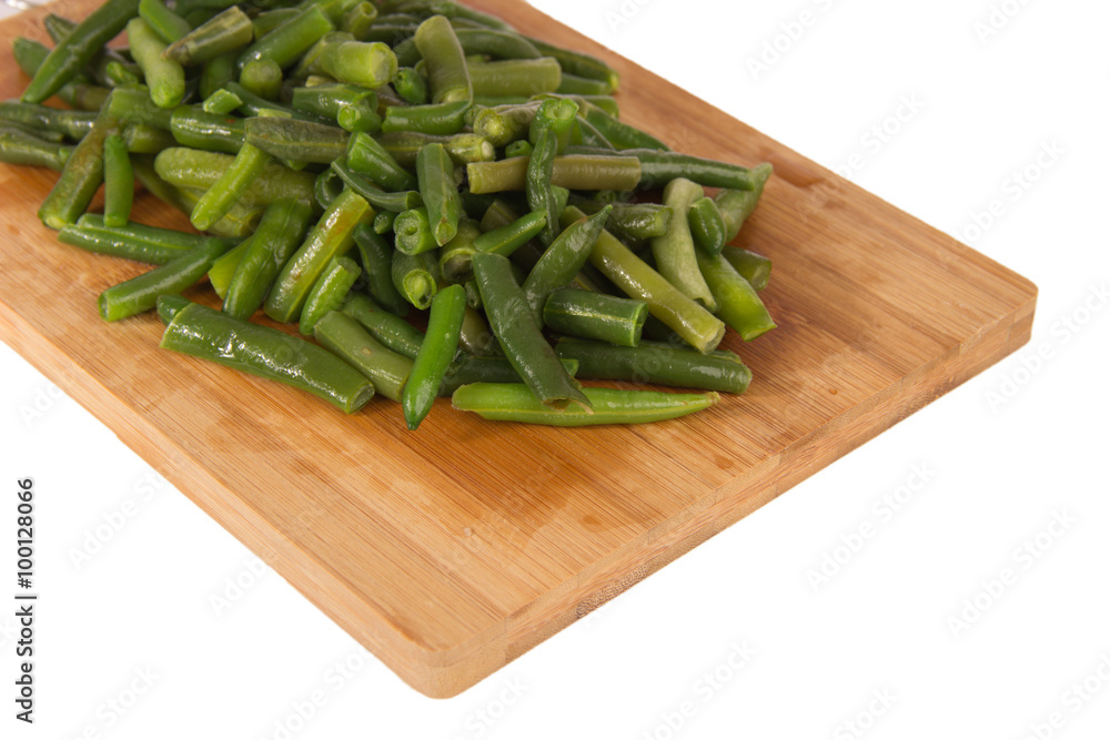 Green string beans on a wooden board Green string beans on a wooden board