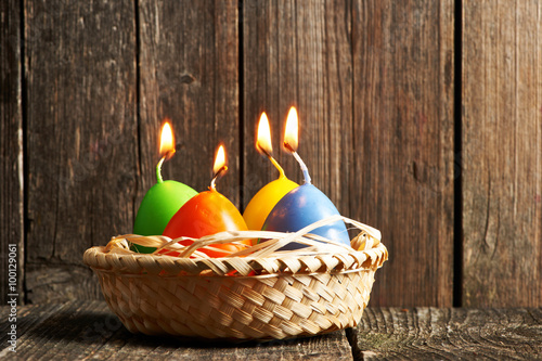 Easter candles on wooden table