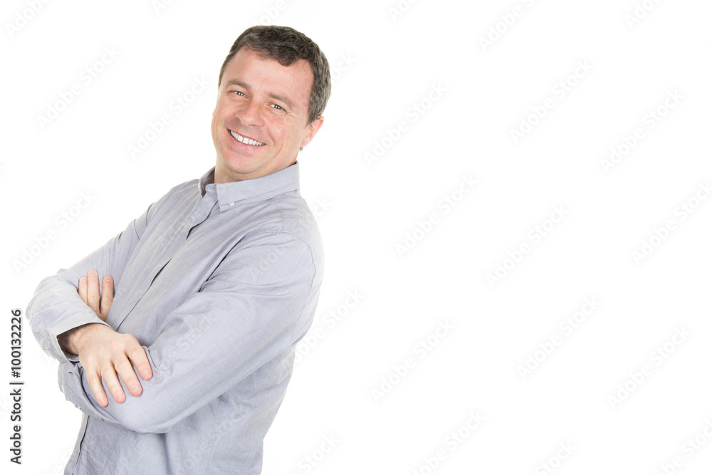 Handsome man in shirt leaning at the copy space and keeping arms crossed Handsome man in shirt leaning at the copy space and keeping arms crossed