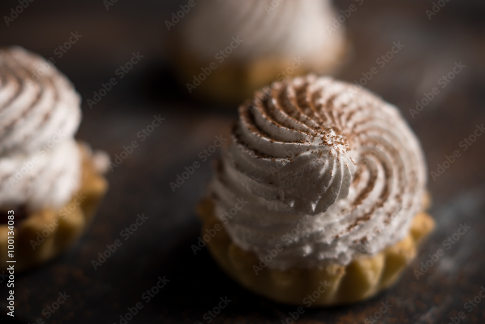 Creamy cake on the dark rustic background. Shallow depth of field. Creamy cake on the dark rustic background. Shallow depth of field.