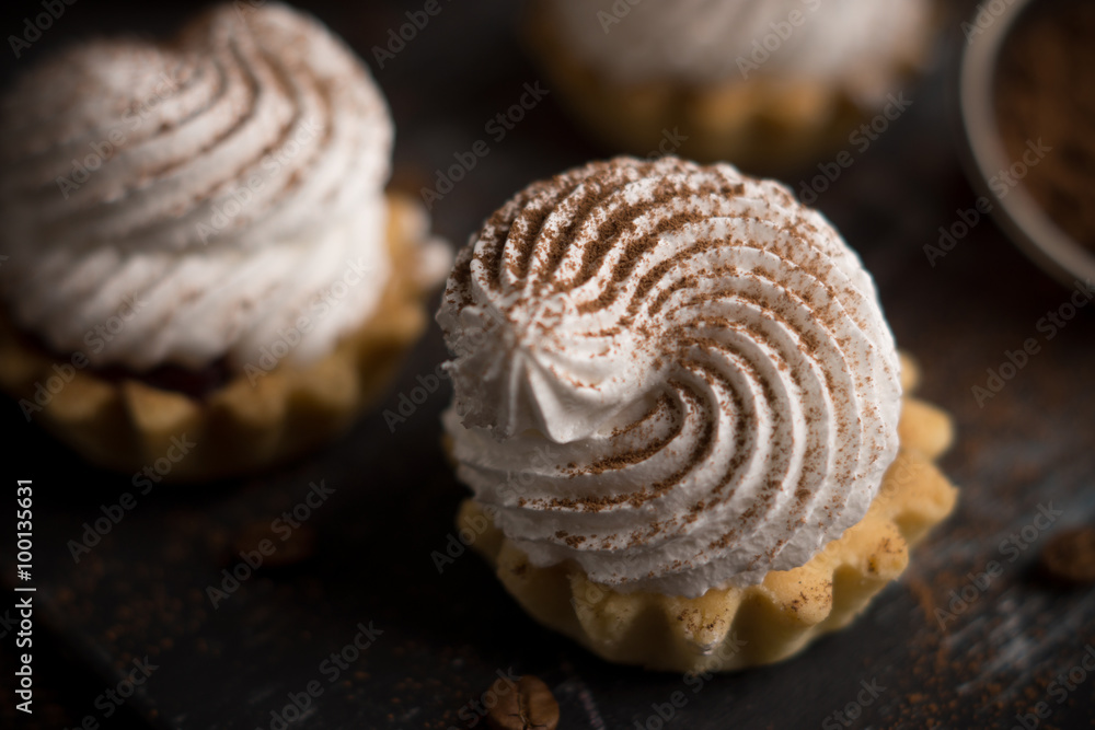 Creamy cake on the dark rustic background. Shallow depth of field. Creamy cake on the dark rustic background. Shallow depth of field.