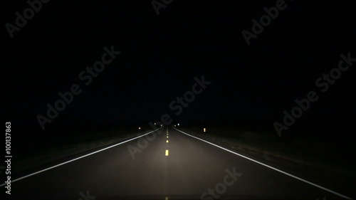 Country Road Driving at Night in Middle Lane. perspective of a vehicle driving at night over the middle lane on country roads using high beam headlights. Swerving back in and out of lane
 photo