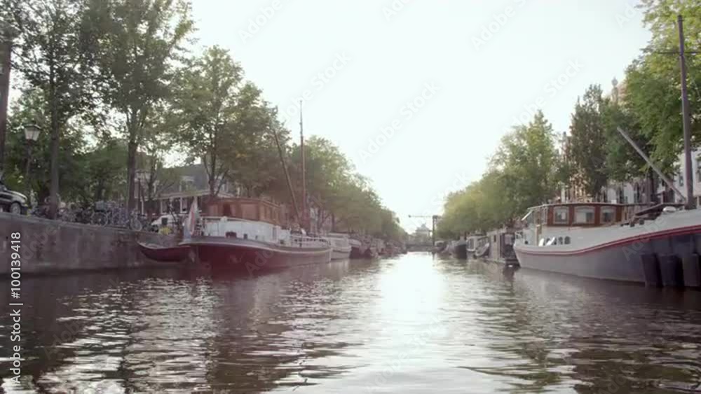 Sped-up shot of houseboats and streets in Amsterdam Sped-up shot of houseboats and streets in Amsterdam