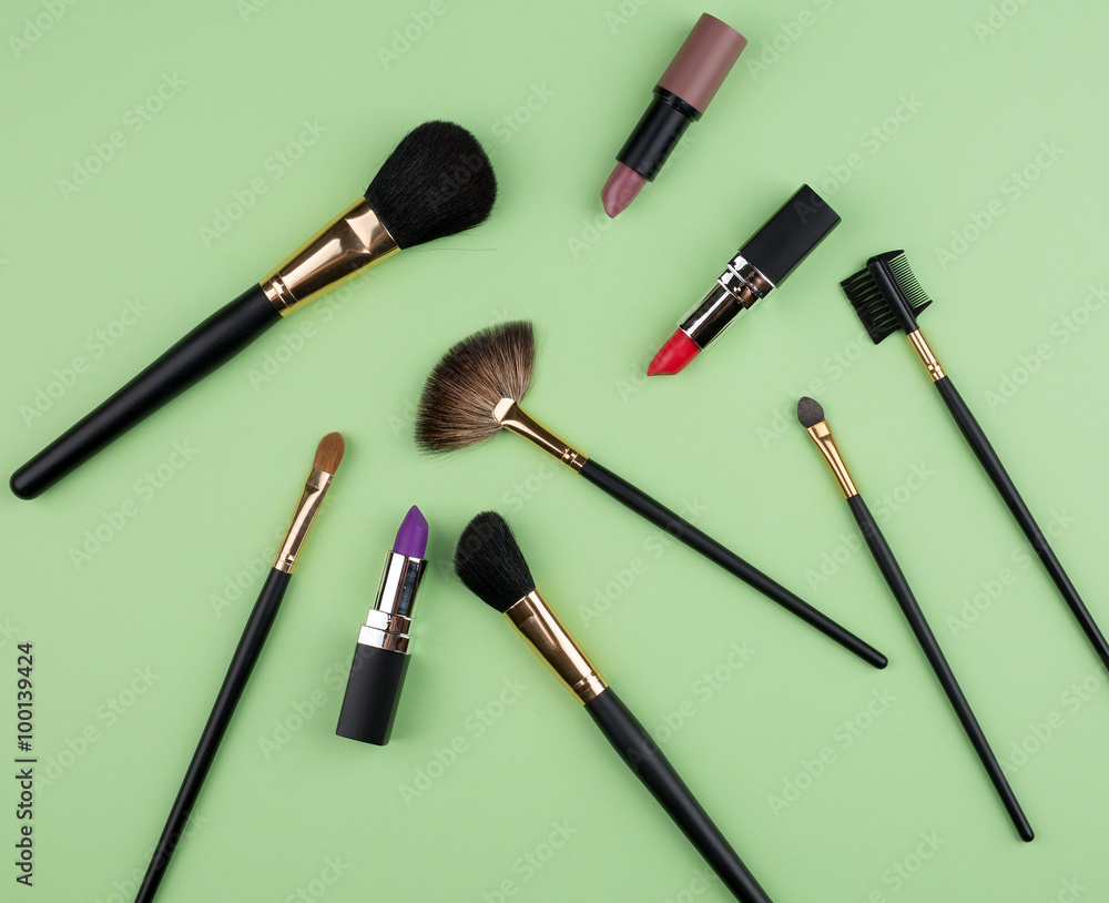Different cosmetics on green background Different cosmetics on green background