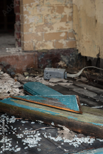 Broken glass and debris inside an abandoned building; vertical image
