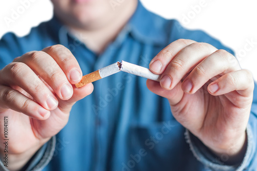 Quit smoking, human hands breaking the cigarette