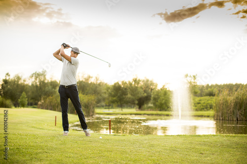 Young man playing golf photo