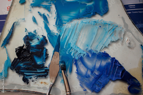 Brush, pallet and blue paints