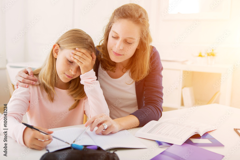 Woman helping out her little sister for homework Woman helping out her little sister for homework